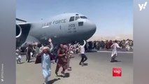 Footage appears to show people clinging to side of US plane amid chaos at Kabul airport