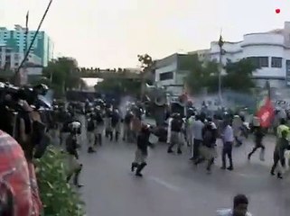 Police try to stop protesters advancing towards US Consulate in Karachi