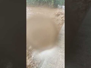 Flash Flooding Forces Debris Under Bridge