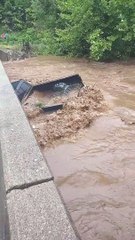 Flash Flooding Forces Debris Under Bridge
