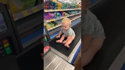Baby Rides Grocery Conveyer Belt
