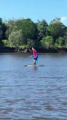 Giant Umbrella Helps Surfboarder Glide Down River