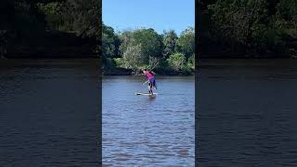 Giant Umbrella Helps Surfboarder Glide Down River