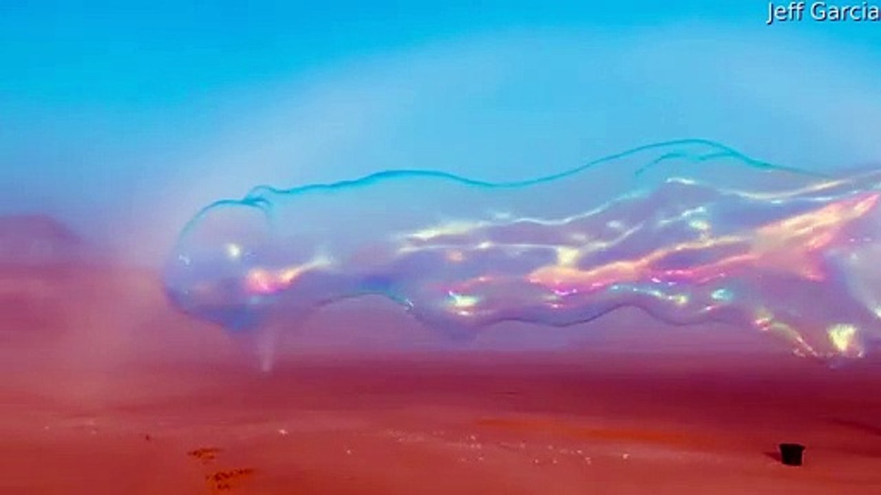 Gigantic Soap Bubble Blown Under White Rainbow