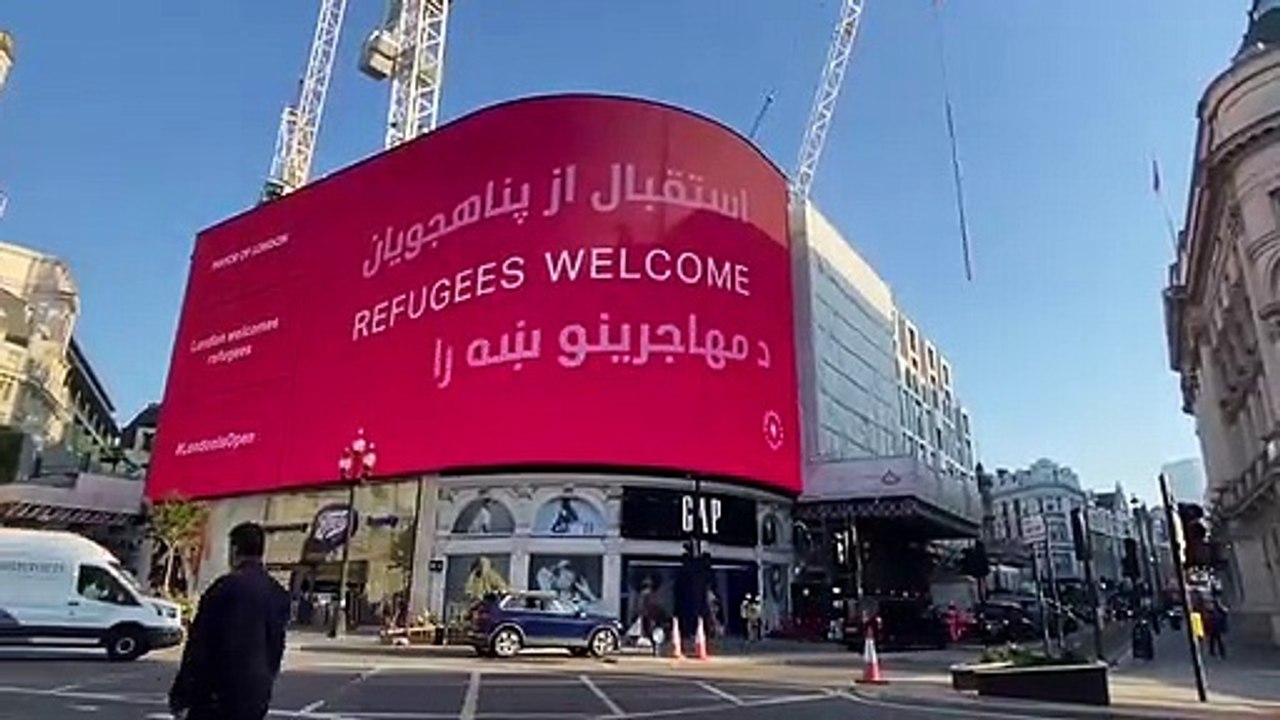 Afghan refugees are welcomed to London with a s...
