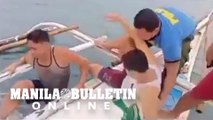 Cops rescue 3 fishermen at sea while holding on to their banca’s bamboo outrigger