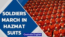 North Korea: Soldiers march in orange hazmat suits| Oneindia News