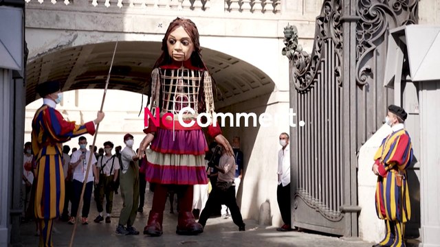 El papa saluda a la pequeña Amal, la marioneta gigante que representa a una niña refugiada siria