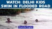 Delhi rain: Children seen swimming and playing on flooded streets | Delhi Airport | Oneindia News