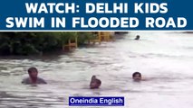 Delhi rain: Children seen swimming and playing on flooded streets | Delhi Airport | Oneindia News