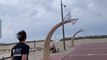 Guy Tries to Score Basket on the Beach Basketball Court but Strong Winds Blow the Ball Away
