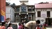 Nepali devotees wash their hands before prayer