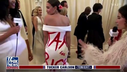 TUCKER CARLSON LAUGH ON AOC WEARING A “TAX THE RICH” DRESS.