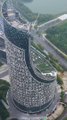 The exterior wall of a skyscraper in Anhui is plastered with Chinese characters. It has a unique shape. Each floor spirals upwards. Netizens say they can’t understand it. Do you know why it was built like this?