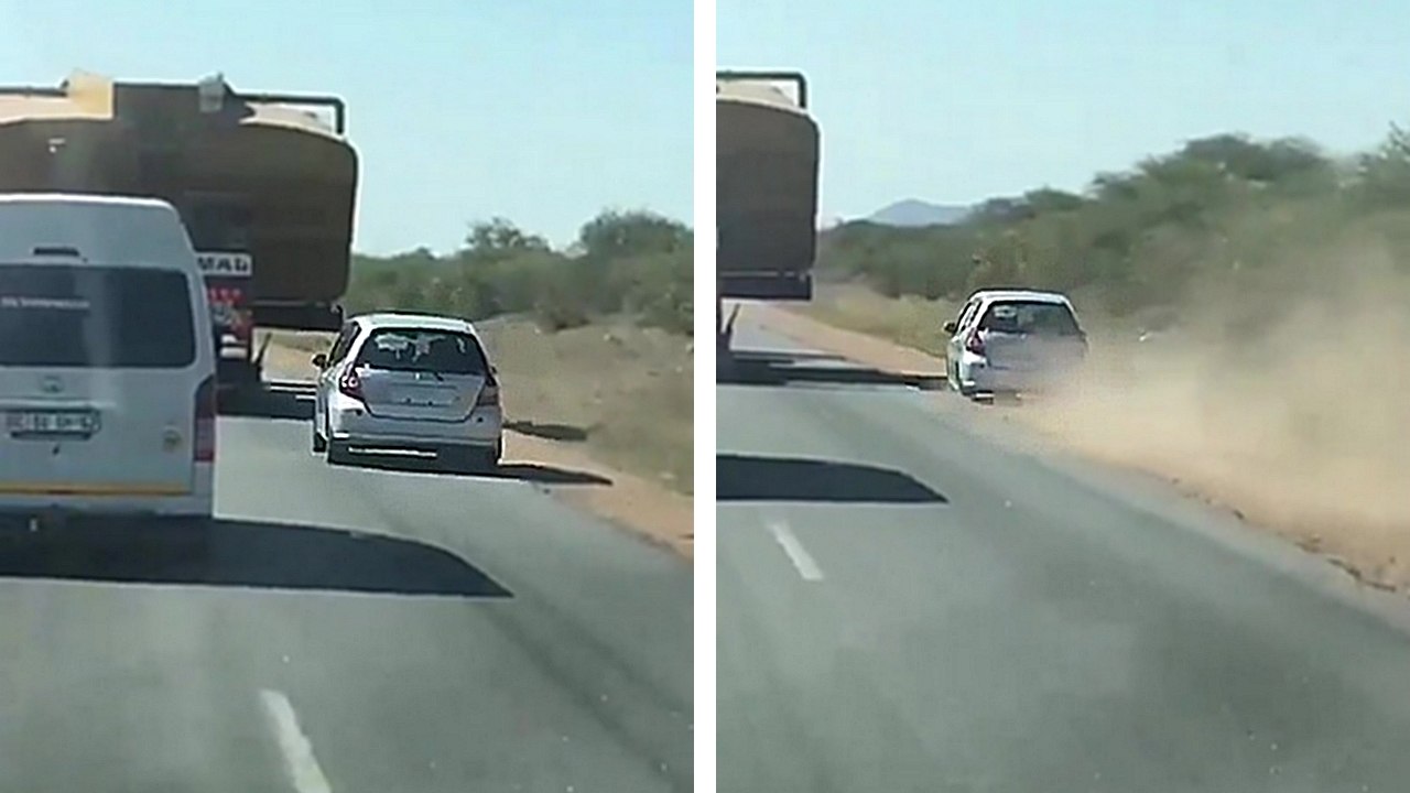 Un automobiliste tente de doubler un camion en passant par le bas-côté