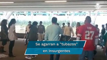 Con tubos y palos, comerciantes se enfrentan en Glorieta de los Insurgentes