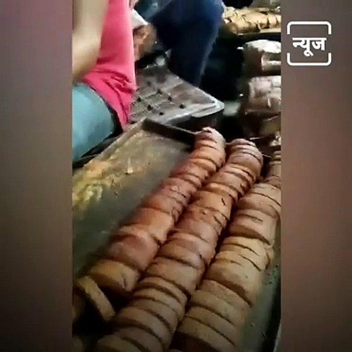Workers in a Biscuit Making Unit Licking Toasts Before Packing.