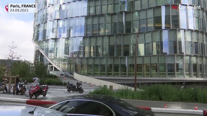 Climber scales Paris building in climate protest