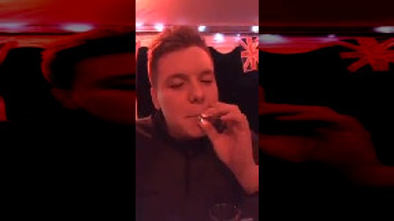Man Messing Around Inhales a Cigarette