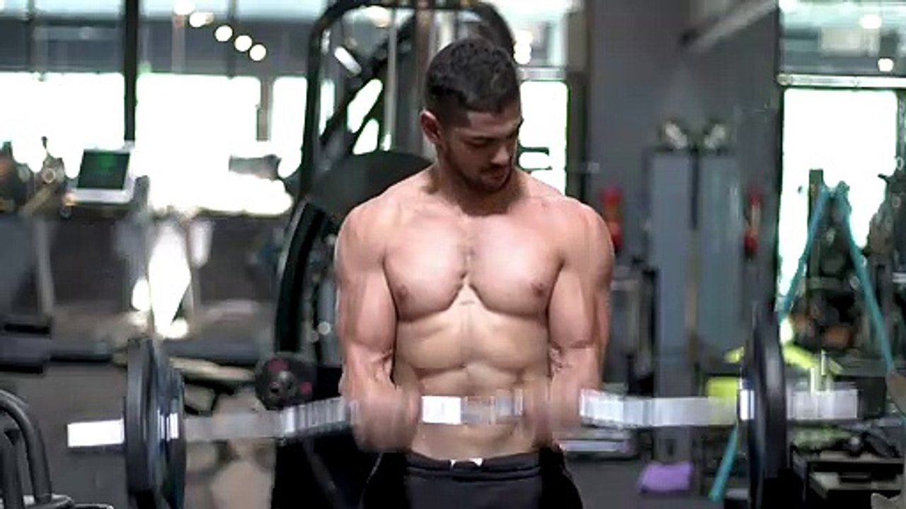 shirtless bodybuilder training in the gym