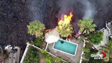 La Palma volcano_ Drone video shows black lava swallowing pool, homes on its way to coast