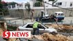 Parked car damaged as road gives way in Penang
