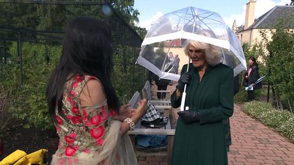 Charles and Camilla brave the elements at Edinburgh gardens