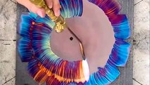Artist torches colorful designs on copper clocks