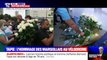 Mort de Bernard Tapie: des Marseillais écrivent des mots sur l'affiche placée devant le Vélodrome et déposent des fleurs en hommage