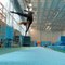 Gymnast Shows Off Cool Tricks While Hanging From Flying Pole