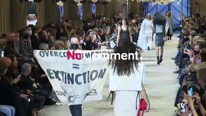 Climate protesters invade the Louis Vuitton fashion show in Paris