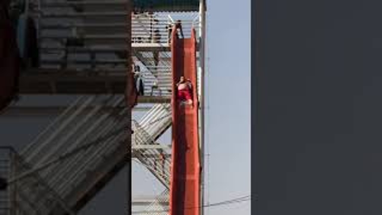 Guy on Slide Collides with Unsuspecting Swimmer