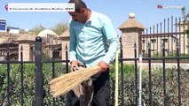 Iraq: a musician plays music with cleaning tools as instruments