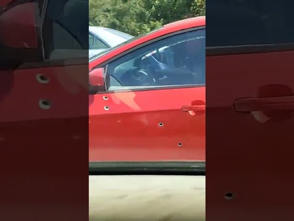 Car Riddled With Bullet Holes