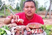 Outdoors eatingshow by Thai man eating seafood with spicy fish sauce