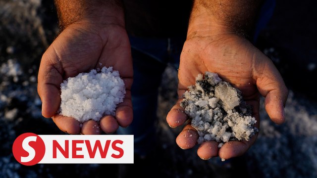 Volcanic ash darkens La Palma's pristine salt flats
