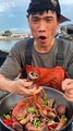 Chinese fisherman eating Seafood vigorously