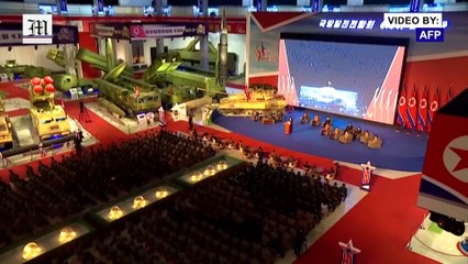 North Korea's Kim speaks flanked by military hardware