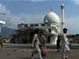 Pigeons fly over the Jama Mosque in Srinagar