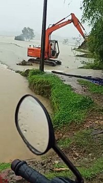 Excavator Returning to Shore Wades Against Floodwaters