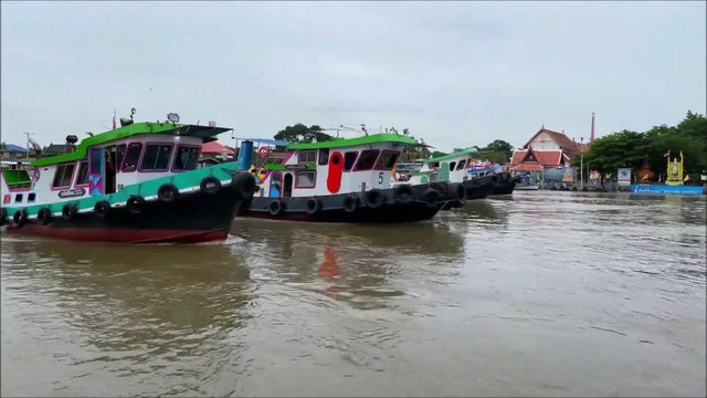 5 Tugboats pulling a barge of Koh Kret at Chao Phraya river in Thailand