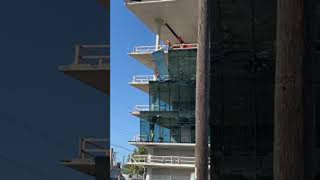 Construction Workers Break Large Glass Window