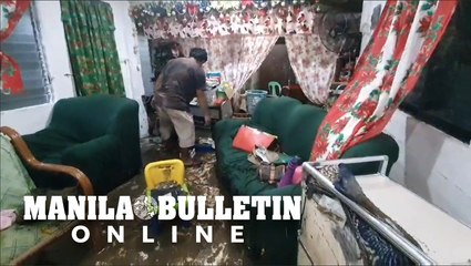 Resident cleans and arranges his belongings after a flash flood hit their home in Northern Cebu