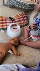 Toddler Feeds Doll With Pump