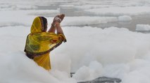 People take dip in toxic Yamuna on first day of Chhath Puja