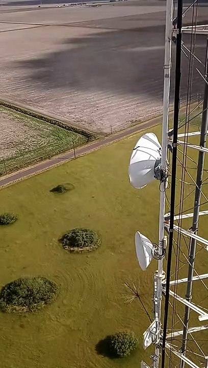 Whirlwinds Spin Grass Below While Working in Tower
