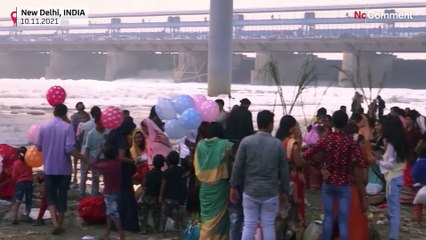 Hindus take holy dip in toxic foam-topped river