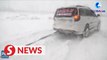 Volunteers help travelers trapped on road by heavy snowstorm in Tongliao, China