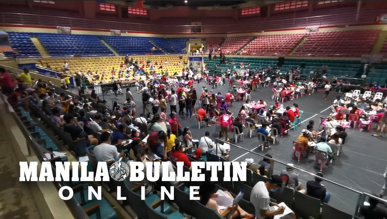 Pasay City residents receive their cash aid from the DSWD at the Cuneta Astrodome