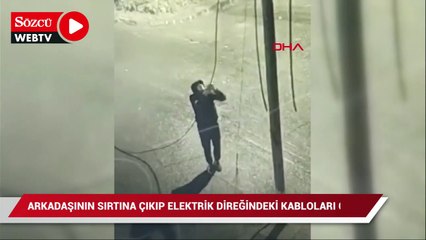 Скачать видео: Arkadaşının sırtına çıkarak elektrik direğindeki kabloları çaldı